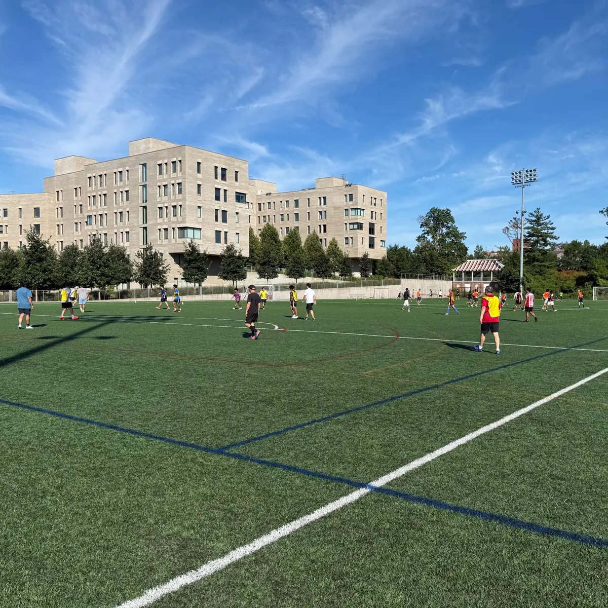 Princeton Soccer Group players taking part in three simultaneous pickup games across the field